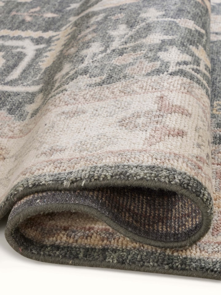 Oushak traditional grey Bhadohi wool hand-knotted rug kharad laid out to show its full pattern and size.