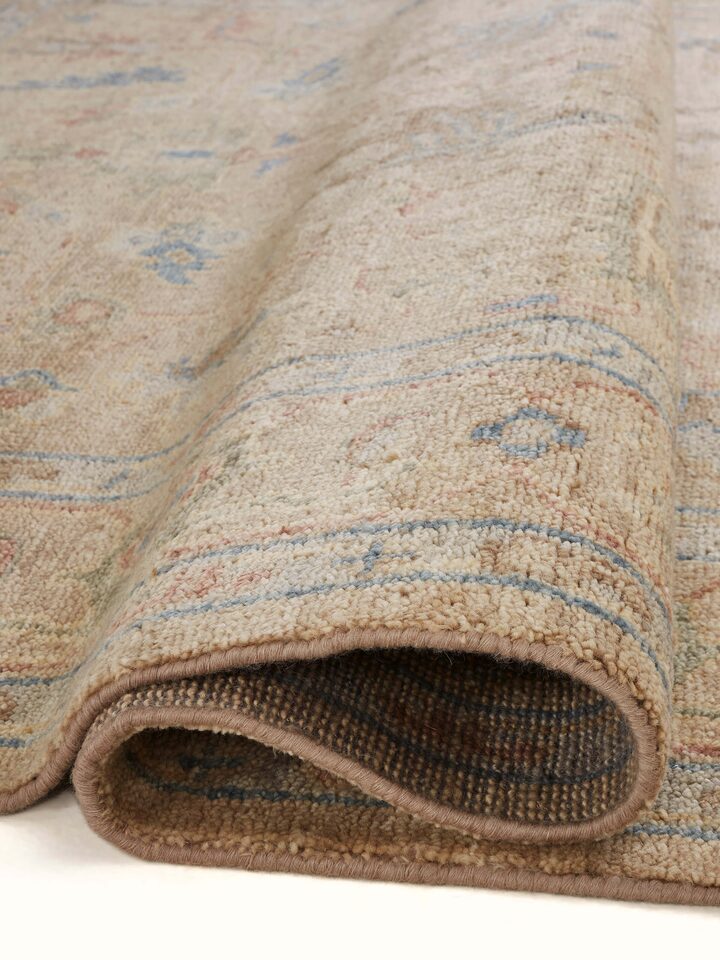 Close-up of Oushak traditional beige Bhadohi wool hand-knotted rug showcasing the detailed wool texture and traditional design
