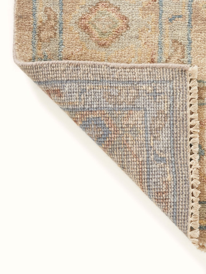 Detailed view of Oushak traditional beige Bhadohi wool hand-knotted rug highlighting the fine craftsmanship and traditional patterns