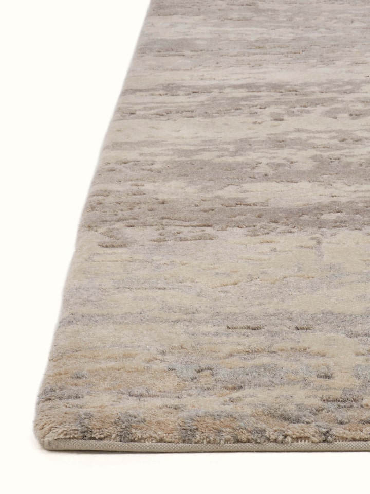 Angle view of Modern Distress Abstract Grey Bhadohi Wool & Viscose Hand-Knotted Rug highlighting color and pattern.