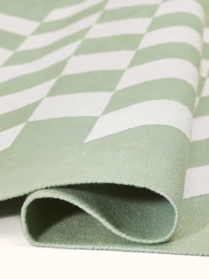 Modern geo chevron light green ivory lawan cotton panja dhurrie kharad arranged to show its full design and texture.