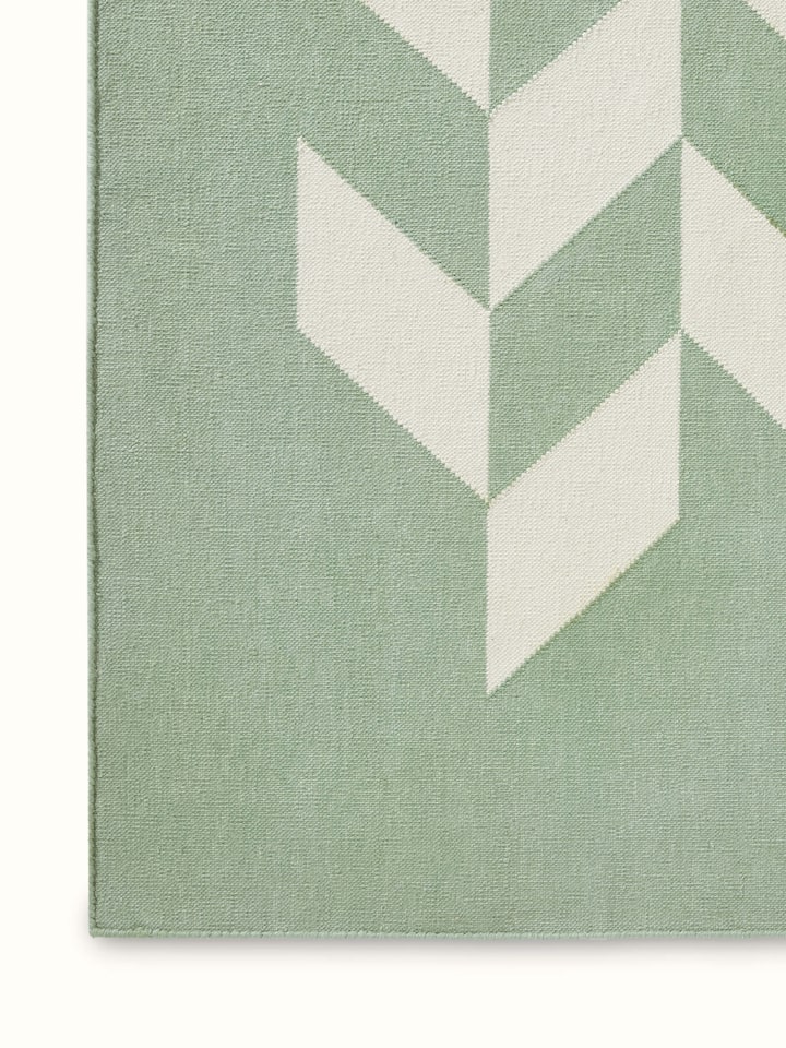 Detailed view of Modern geo chevron light green ivory lawan cotton panja dhurrie kharad showcasing the chevron pattern and colors.