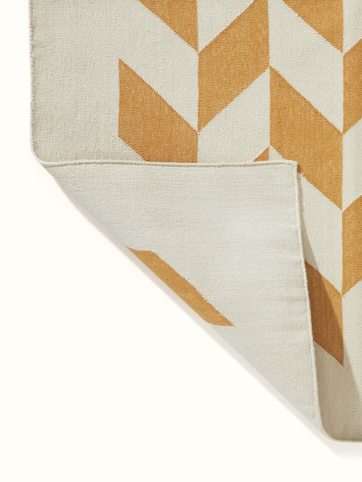 Modern Geo grey tan Lawan dhurrie folded, showing its compact and stylish design