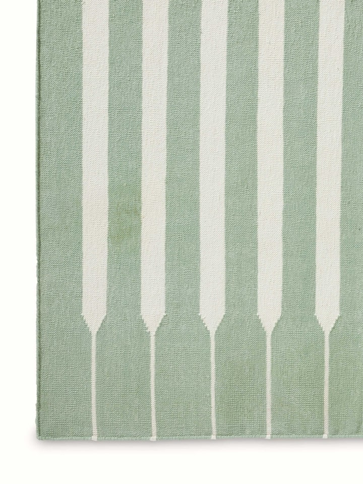 Detailed view of Modern geo stripe light green ivory lawan cotton panja dhurrie kharad showing the fine cotton weave and stripe patterns.
