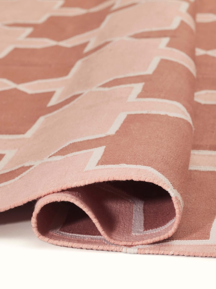 Close-up of Modern Geo Red Blush Lawan Cotton Panja Dhurrie showing the quality of the fabric and intricate design