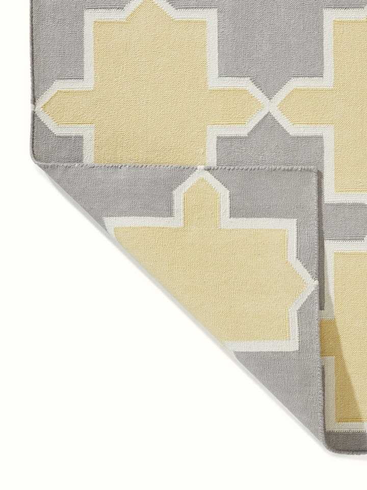 Close-up of Modern Geo grey yellow Lawan cotton panja dhurrie focusing on the geometric patterns and color details