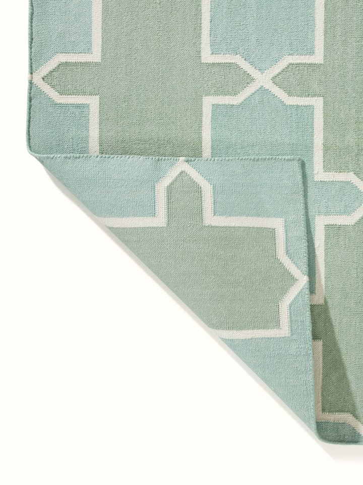 Flat lay of Modern Geo Green Lawan Cotton Panja Dhurrie displaying the overall pattern and color scheme