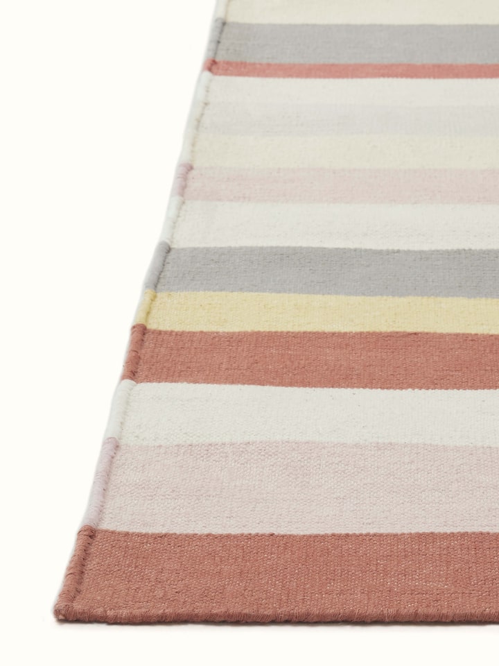 Detailed view of Modern geo stripe rust lawan cotton panja dhurrie focusing on the geo stripe pattern and fabric quality.