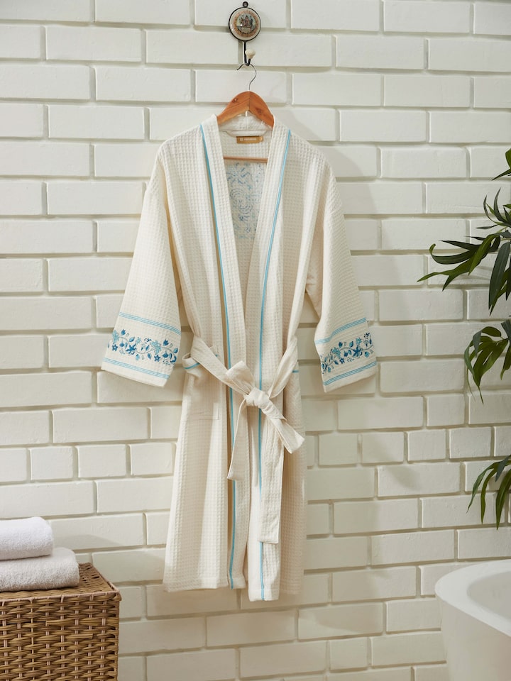 Detailed view of Blue floral cotton Sanganeri block printed bathrobe showcasing the vibrant floral design and fabric texture.