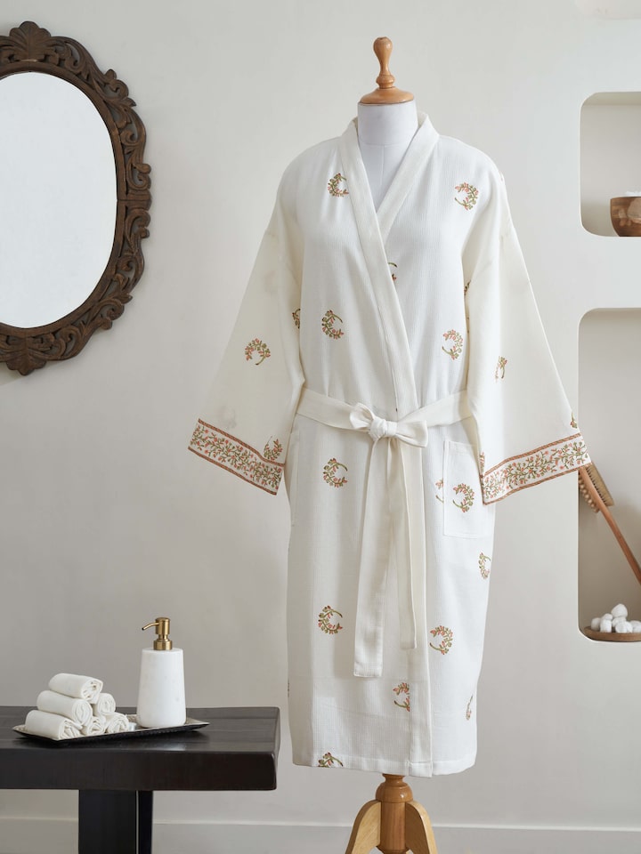 Styled view of Ambi Buta Peach Floral Cotton Sanganeri Block Printed Bathrobe styled on a model, from a different angle