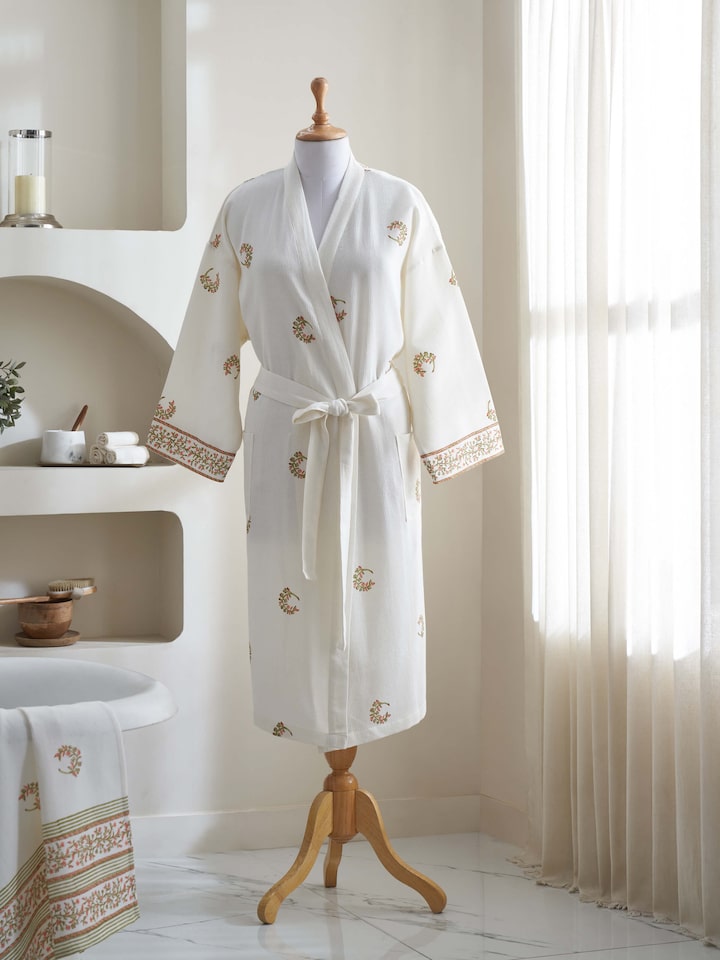 Styled view of Ambi Buta Peach Floral Cotton Sanganeri Block Printed Bathrobe styled on a model, in an alternate close-up