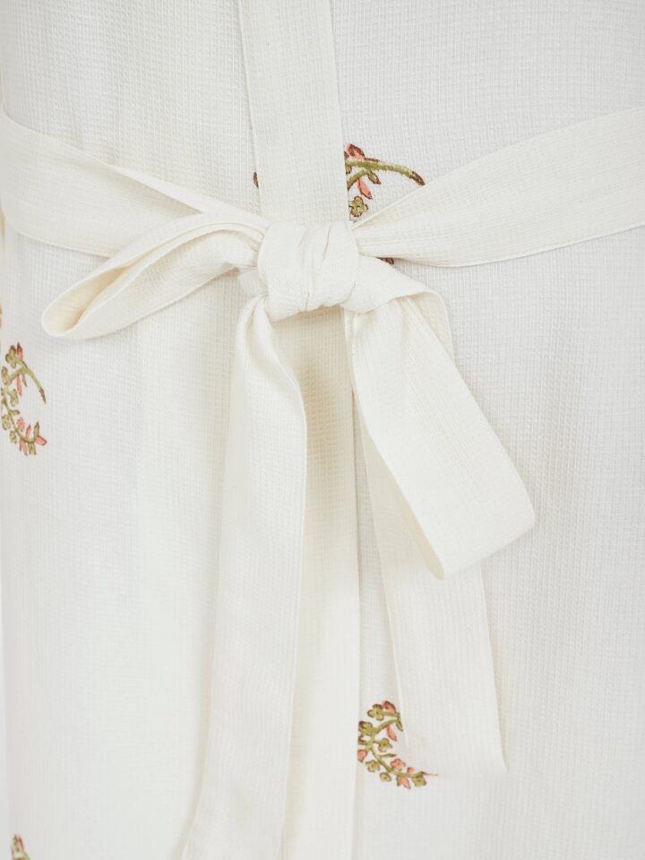 Detail view of Ambi Buta Peach Floral Cotton Sanganeri Block Printed Bathrobe highlighting the embroidery and stitch detail, in an alternate close-up