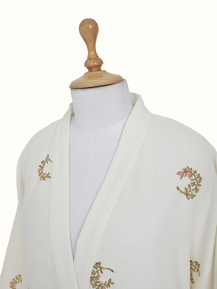 Detail view of Ambi Buta Peach Floral Cotton Sanganeri Block Printed Bathrobe highlighting the embroidery and stitch detail, with a slightly differ...