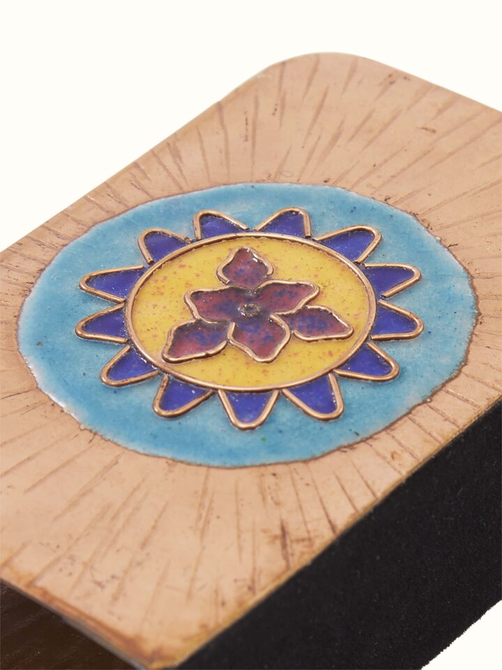 Angled view of copper sunshine square card holder in blue, highlighting its elegant design