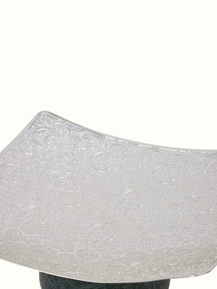 Detailed view of silver-plated paisley square platter with focus on pattern and shine.
