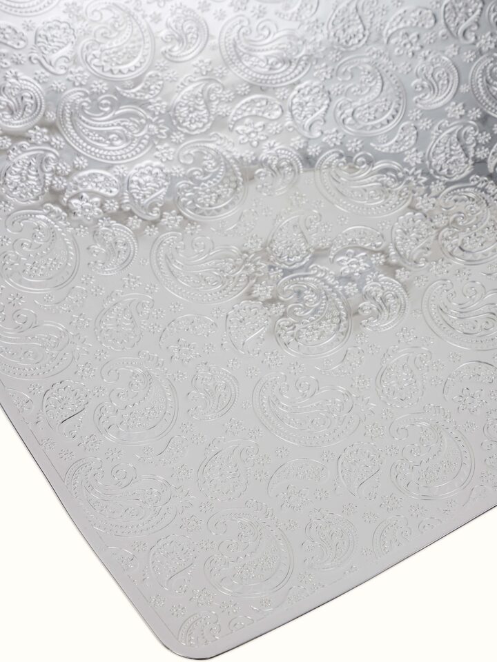 Close-up of silver-plated paisley square platter showing ornate paisley design.