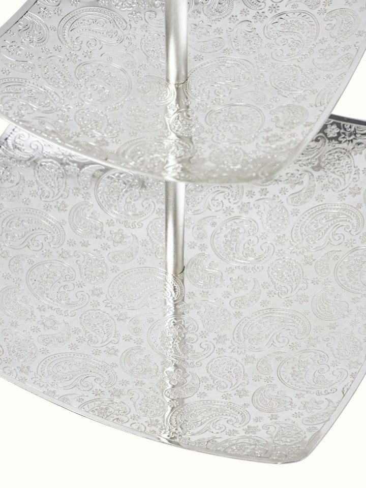 Side view of silver-plated paisley 2-tier square platter highlighting the tiered design and ornate patterns