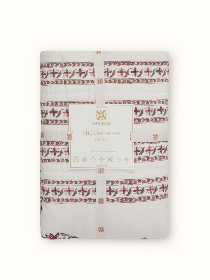 Aarunya red floral cotton pillow shams folded, showing the Sanganeri block print and rich red floral design in detail.