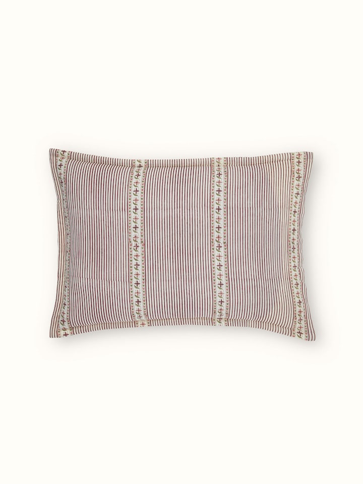 Aarunya red floral cotton pillow shams arranged to highlight the repeating Sanganeri block print pattern and color contrast.