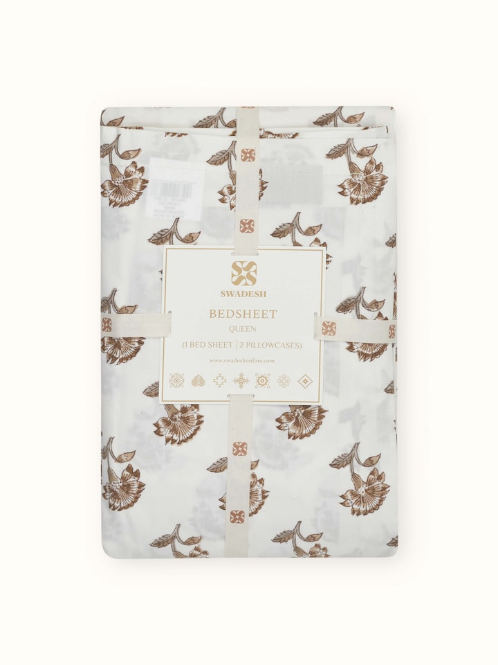 Perspective view of Aarunya beige floral cotton Sanganeri block printed queen bedsheet set (3 pcs) highlighting the full floral design and color.