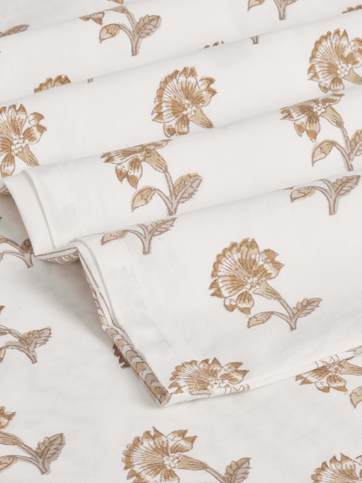 Detailed view of Aarunya beige floral cotton Sanganeri block printed queen bedsheet set (3 pcs) showing the block print and cotton fabric.