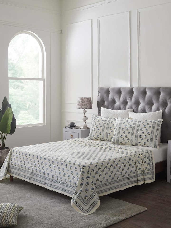 Side view of Aarunya Blue Buti Cotton Sanganeri Block Printed Queen Bedsheet Set (3 pcs) highlighting the bedsheet's design and print.