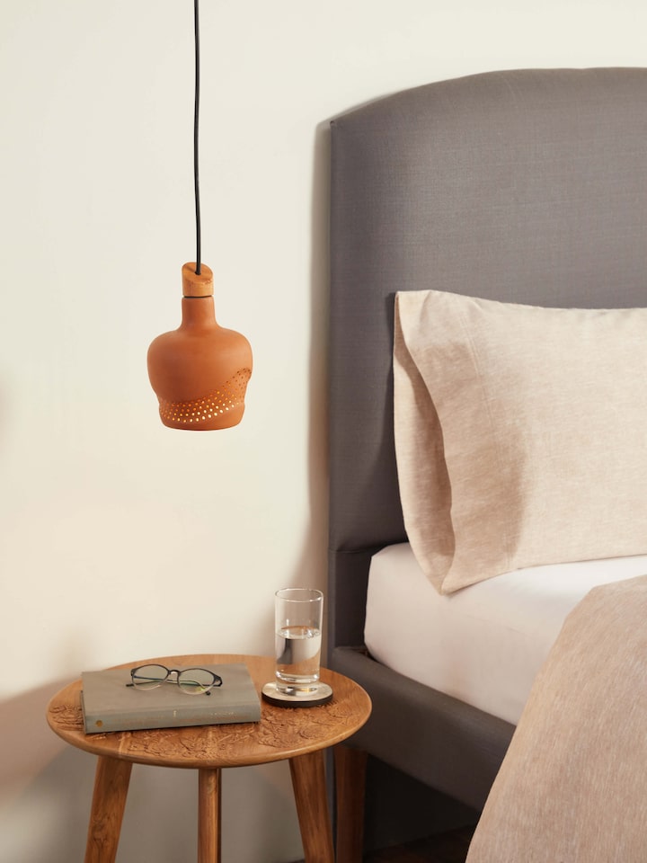 Side view of terracotta pendant lights, showcasing the overall shape and craftsmanship of the set.