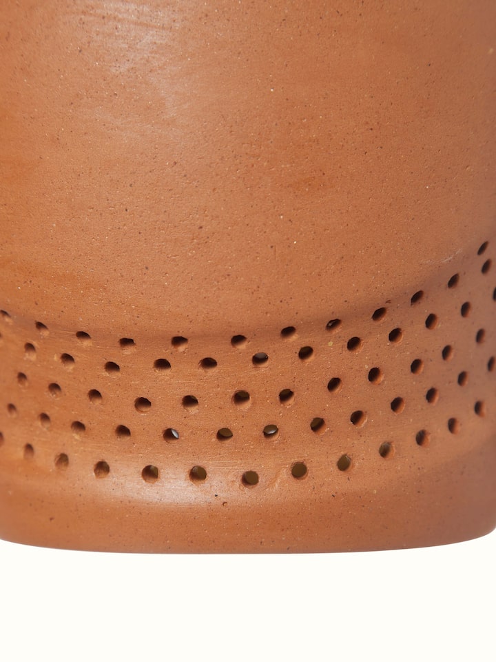 Terracotta pendant lights set against a neutral background, illustrating their versatility and design.