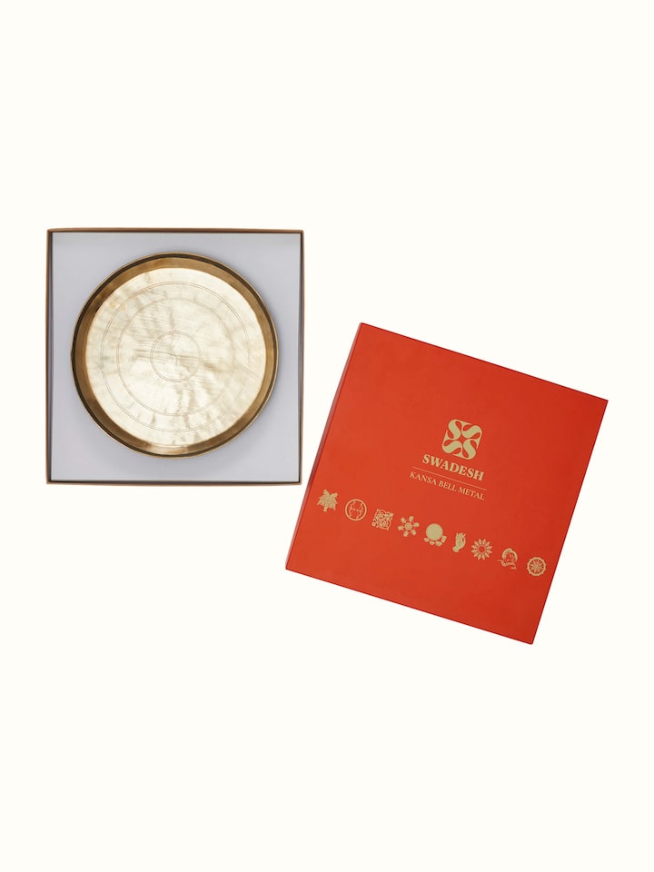 Angled view of Bell Metal Dinner Plate (11 inches) showing its elegant curvature and metal finish.
