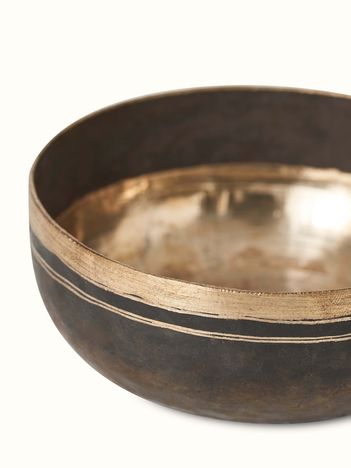 Side angle view of Bell metal dinner bowls highlighting the elegant contours.