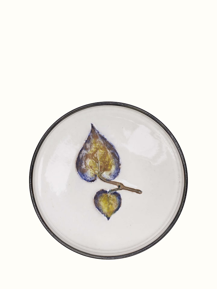 Close-up of studio pottery ceramic dessert plate highlighting its unique glaze and texture
