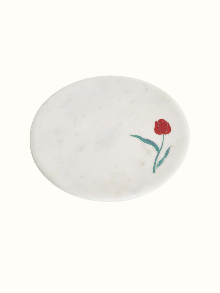 Detailed shot of marble inlaid cake stand showing close-up of the intricate inlay work and smooth finish.