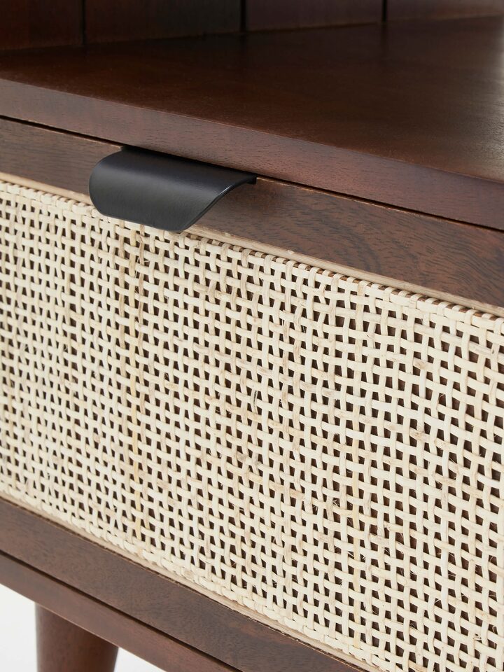 View of the bedside table with its drawer open, showcasing the functional and decorative features.