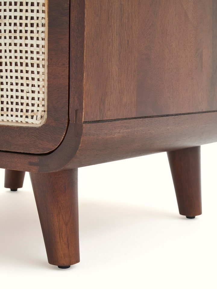 Perspective view of the mango wood and cane bedside table, highlighting the elegant design and sturdy construction.