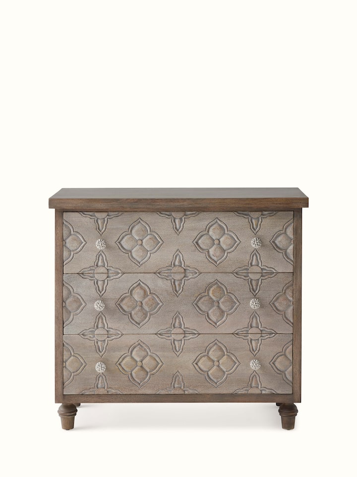 Front view of the carved mango wood chest of drawers, showcasing detailed carvings and elegant design