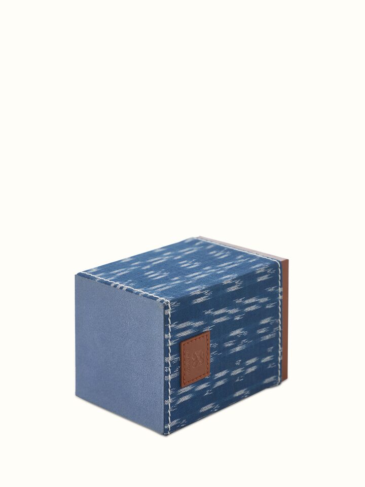 Close-up of blue leather pen cup, showcasing the refined leather texture and functional design elements