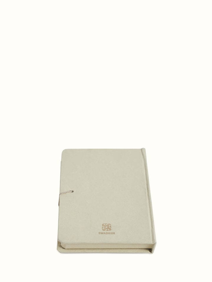 Angle view of Warli painted paper journal in brown emphasizing the craftsmanship and intricate Warli designs