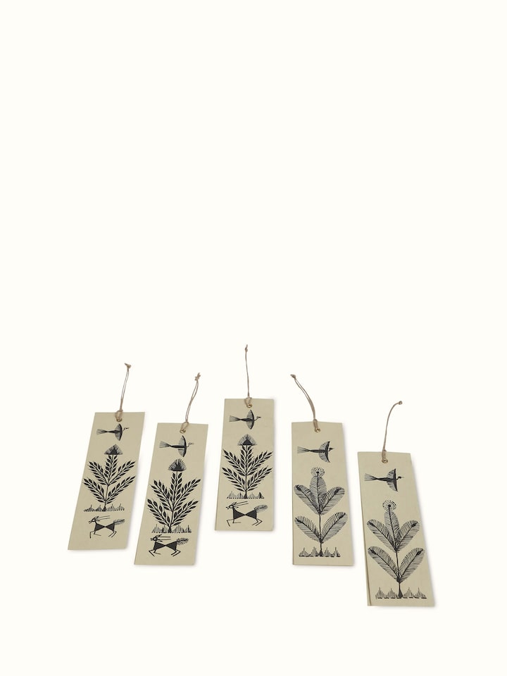 Close-up view of Warli painted paper bookmarks in brown highlighting the fine detail of the tribal art.