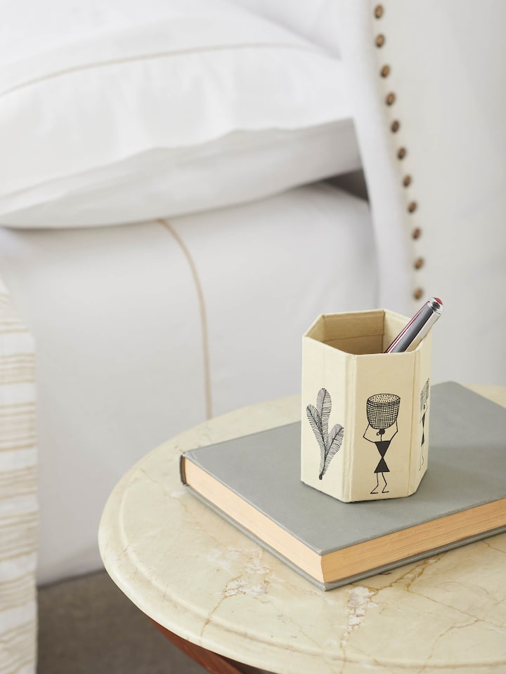 Side view of Warli Painted Paper Pen Stand in brown, highlighting the intricate Warli designs and craftsmanship