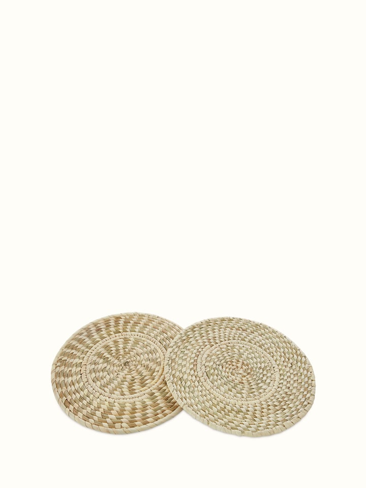Angled view of Kanshi basketry natural fibre trivets, showing their functional design and natural material.