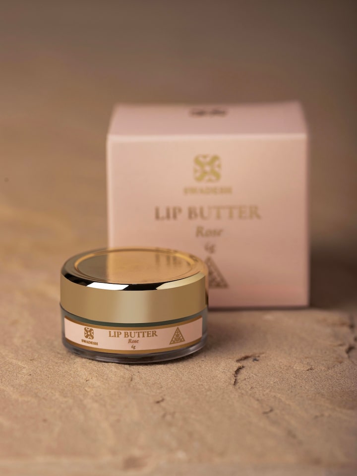 Close-up of Lip Butter Rose jar showing the label, texture of the product, and fine details of the packaging.
