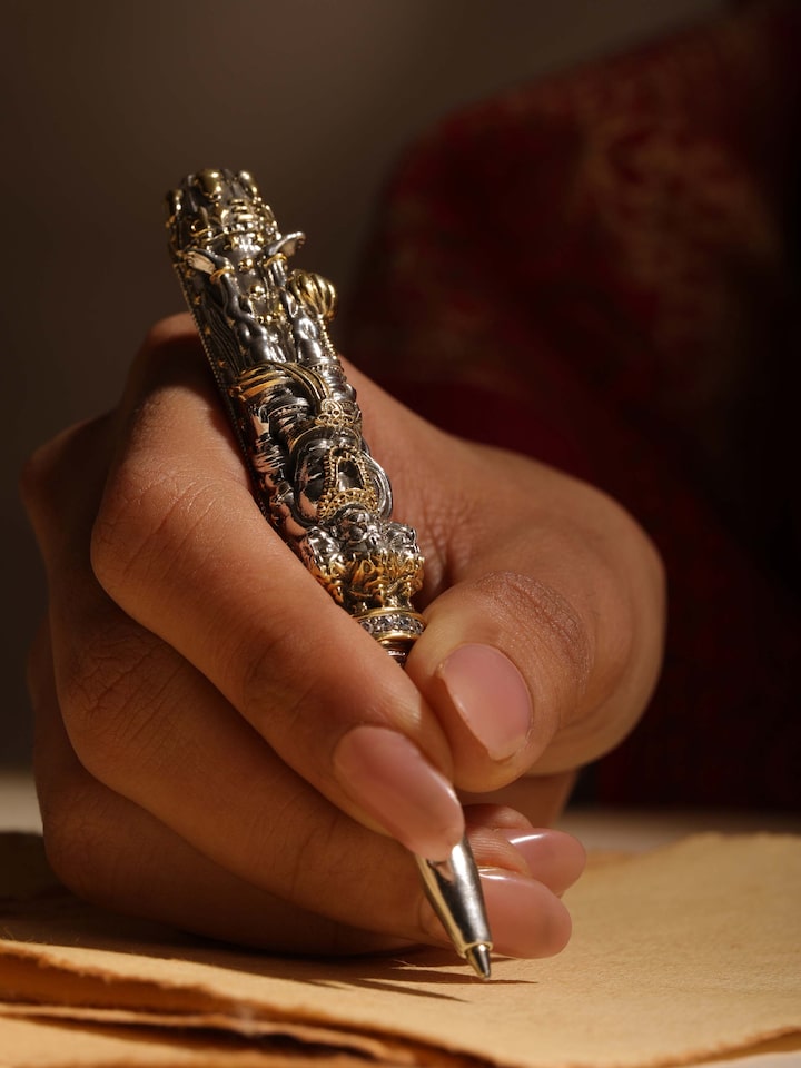 Styled detail view of Lord Hanuman Silver Smithing Pen held in hand, shown in another styled shot