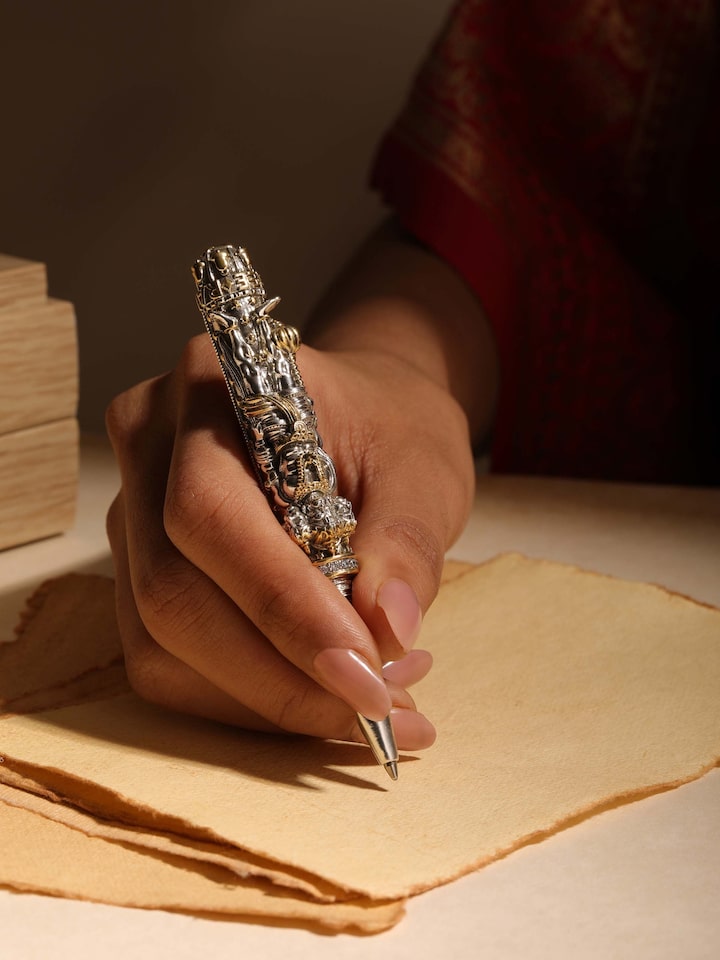 Styled detail view of Lord Hanuman Silver Smithing Pen held in hand, shown in an alternate styled shot