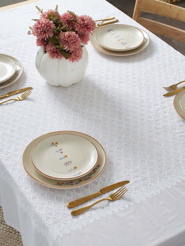 Side view of beige studio pottery ceramic dinner plates set of 4, showcasing their smooth finish