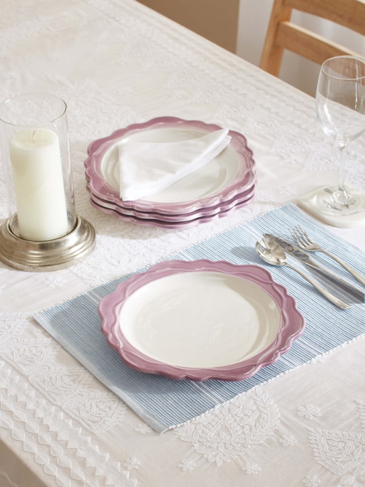 Side view of studio pottery ceramic dinner plates in pink (4 pcs) showcasing their design and texture.