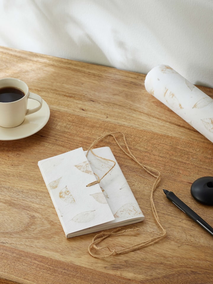 Side view of Auroville Handmade Paper Notebook with Rope in white, showing the binding and cover details.