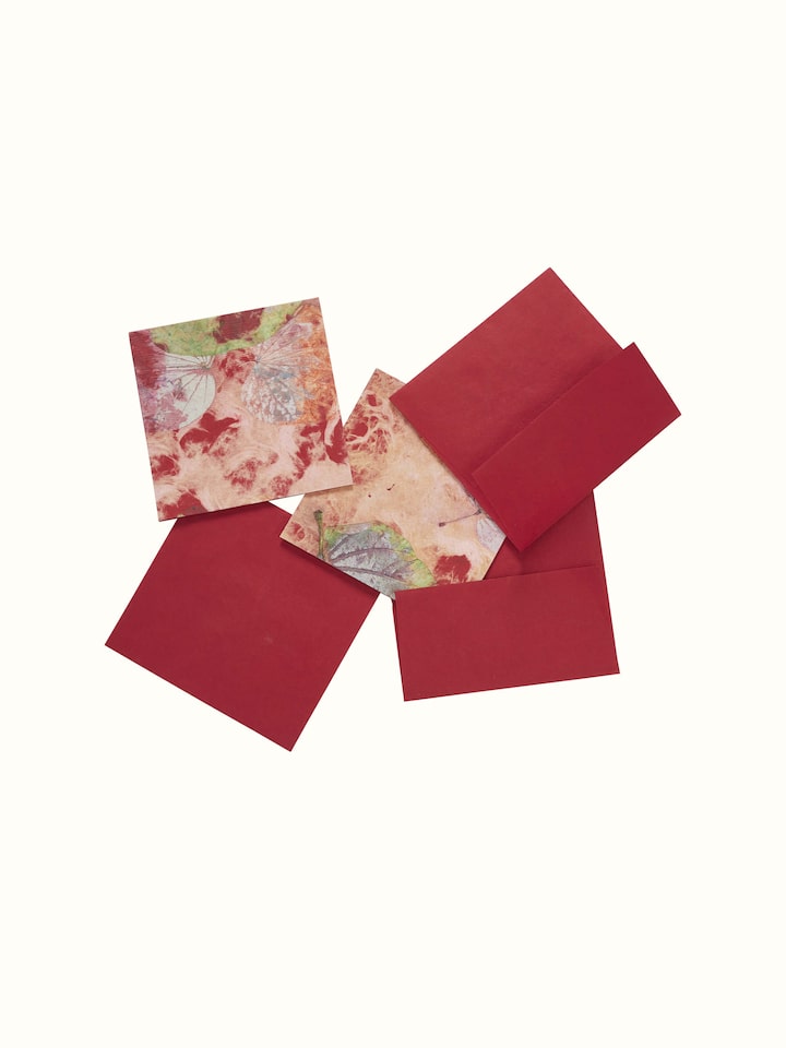 Close-up of Auroville Handmade Paper Money Envelope in red, focusing on the intricate details and craftsmanship