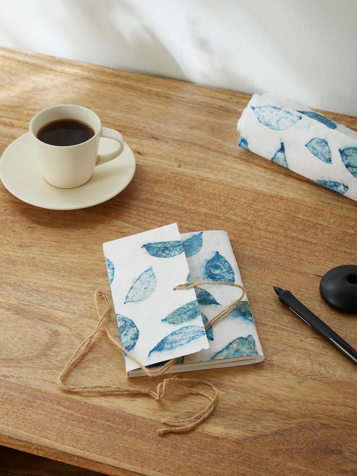 Side view of Auroville handmade paper notebook with blue rope binding, highlighting the craftsmanship