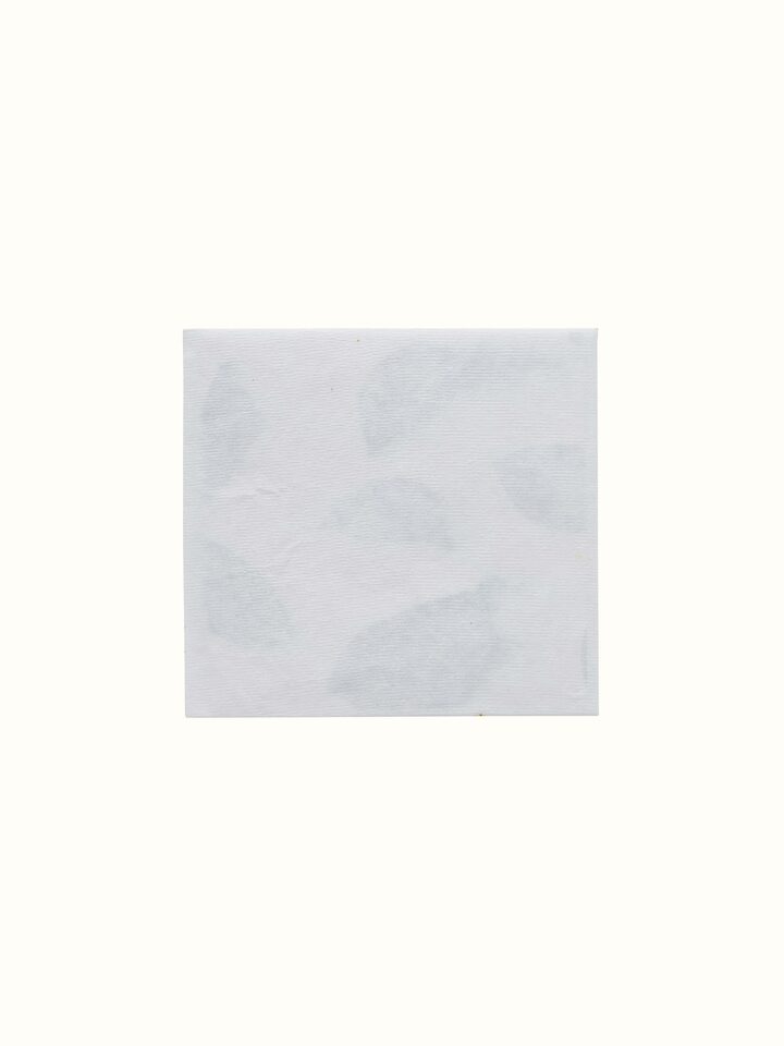 Artistic detail of Auroville handmade white paper money envelopes emphasizing the elegant design and craftsmanship