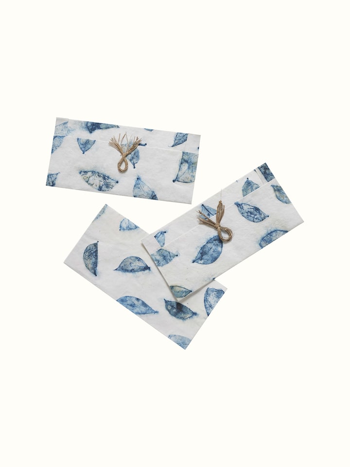 Detail shot showing intricate designs and craftsmanship of the blue envelopes